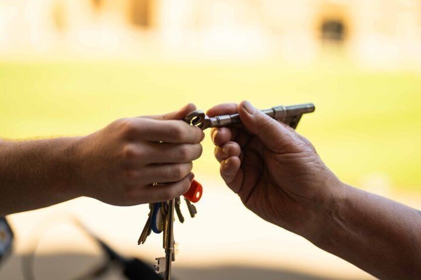 A hand exchanging keys with another hand. 5