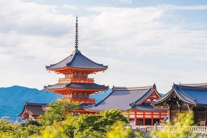 A traditional Japanese pagoda with multiple tiers, surrounded by lush greenery and mountains in the background. 3