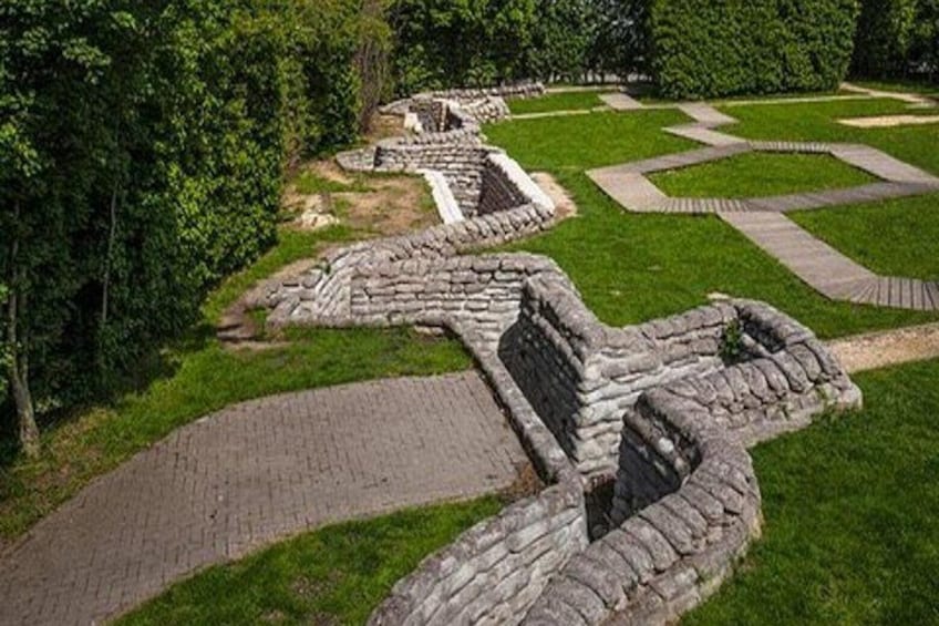 Ancient stone ruins with pathways and a grassy area. 4