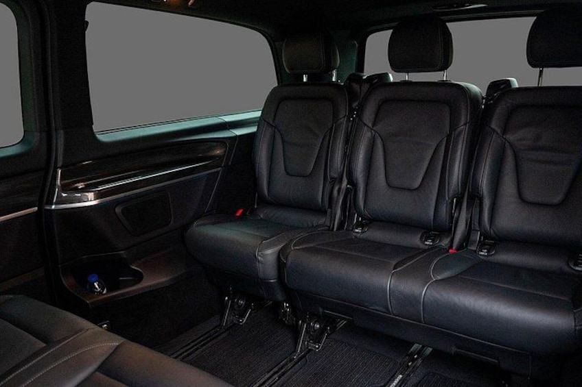 A vehicle interior with black leather seats, a center console, and a sunroof. 2