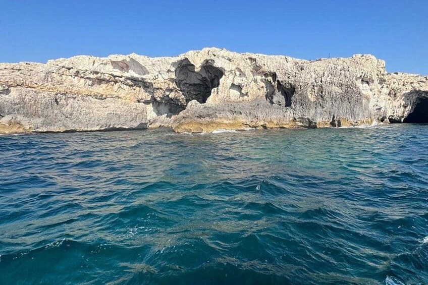 A rocky coastline with clear blue waters. 4