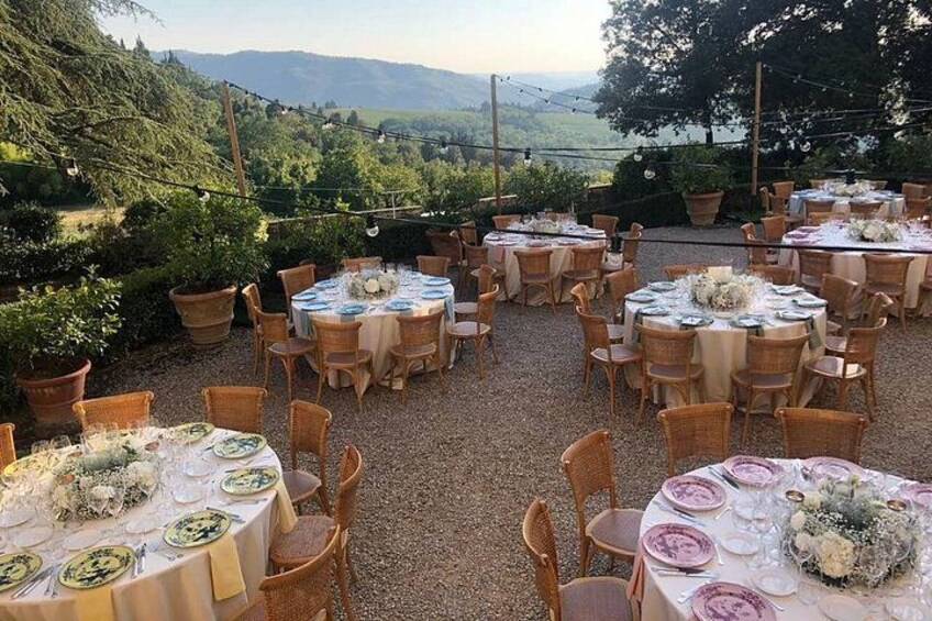 Un espace de restauration en plein air, avec des tables et des chaises rondes, entouré de verdure et offrant une vue sur un paysage pittoresque. 4