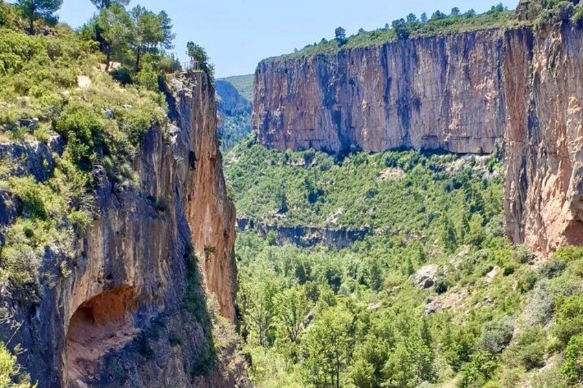 A canyon with steep cliffs and a narrow passageway. 2