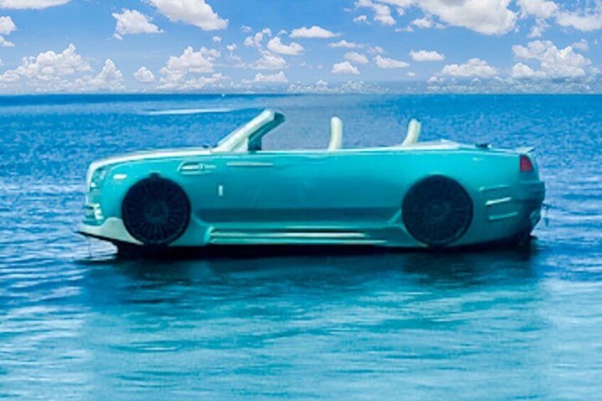 A teal convertible car floating on water with a clear sky and clouds in the background. 2