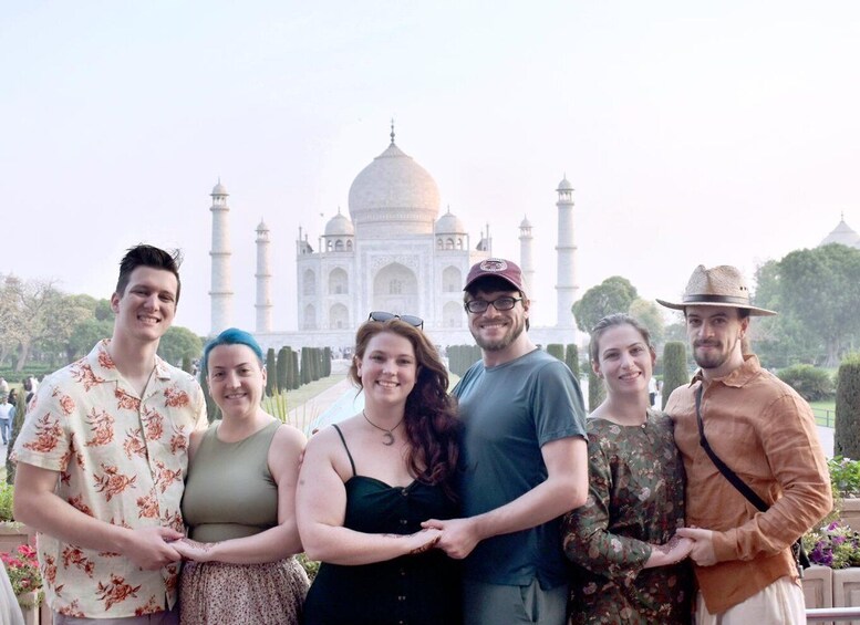 A group of people standing in front of the Taj Mahal. 4