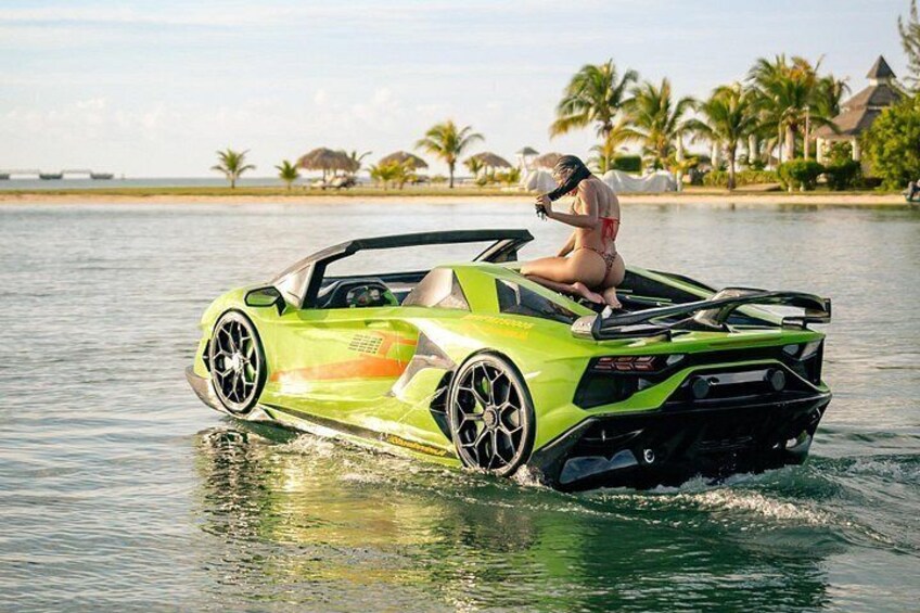 A green sports car driving on water. 1
