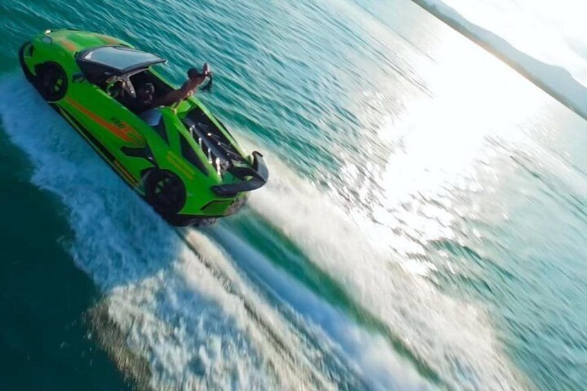 A green speedboat on water. 5