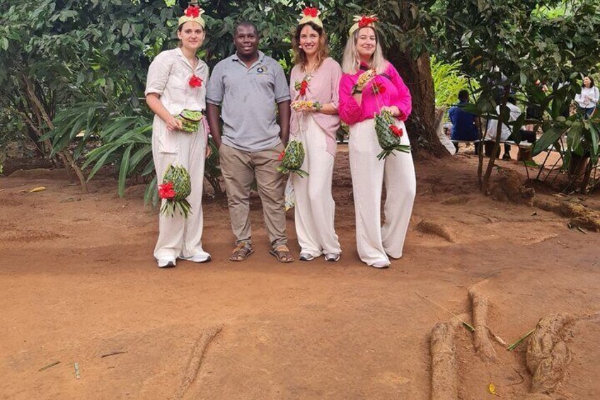 Four people standing outdoors with plants. 5