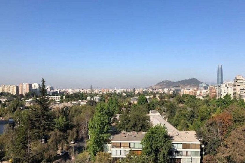 A cityscape with a prominent skyscraper, dense residential buildings, and a hilly background. 5