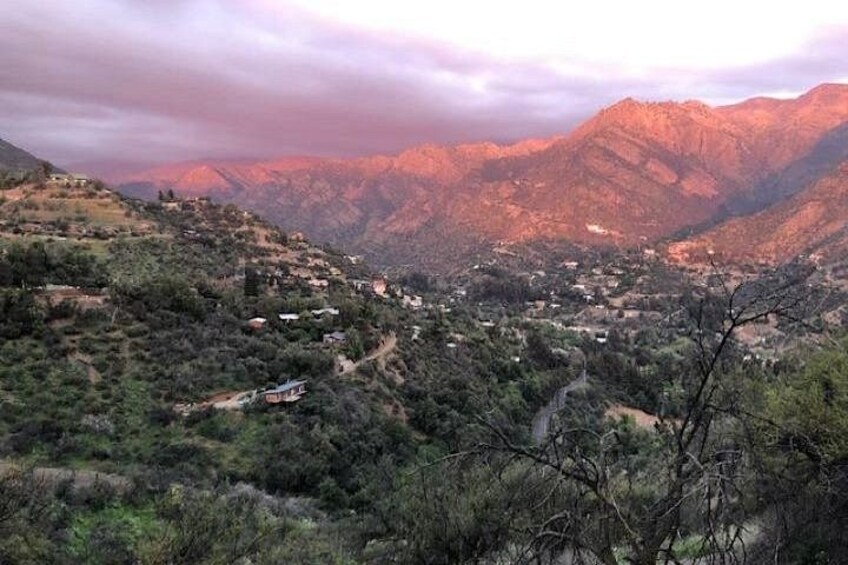 A mountainous landscape with a small settlement nestled among the hills. 2
