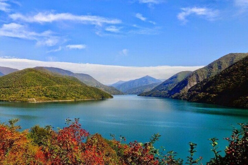A lake surrounded by mountains with autumn foliage. 2