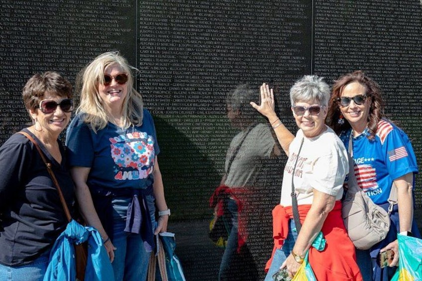 A memorial wall with names inscribed. 2