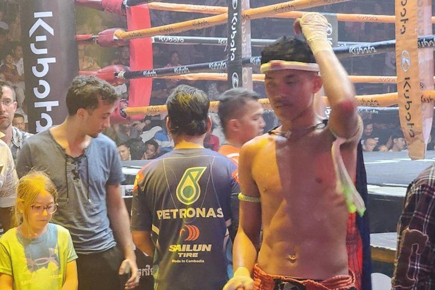 A boxing ring with a crowd of people around it. 3