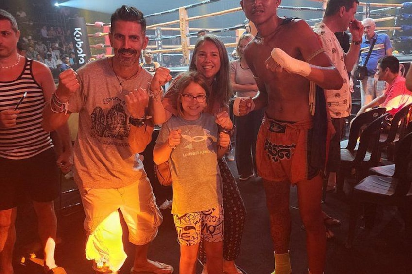A boxing ring with people around it. 5