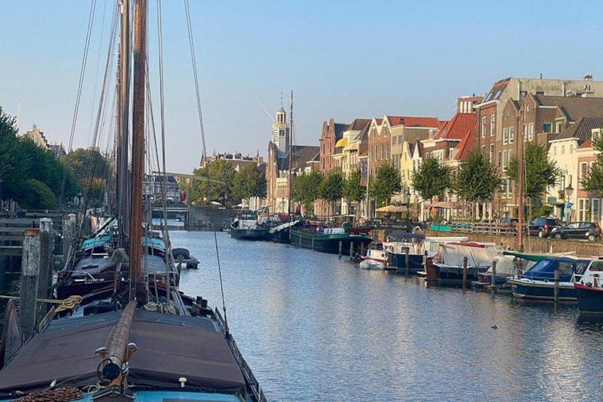 A canal with boats, a bridge, and historic buildings. 3