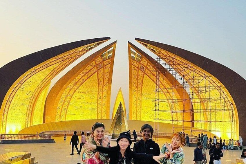 A large, modern building with a golden facade and a central spire. 5
