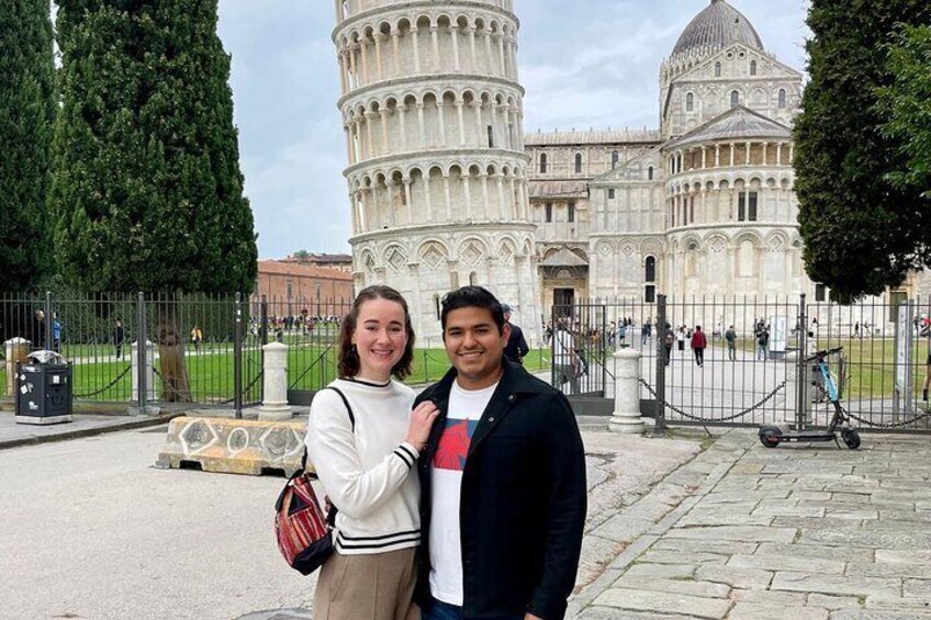 A couple standing in front of the Leaning Tower of Pisa. 2