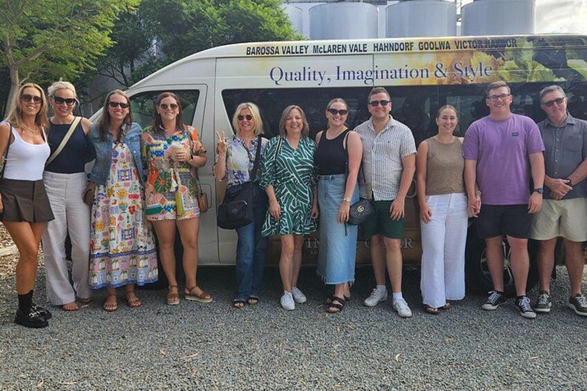 A group of people standing in front of a bus with a sign that reads 'Quality, Imagination & Style.' 5
