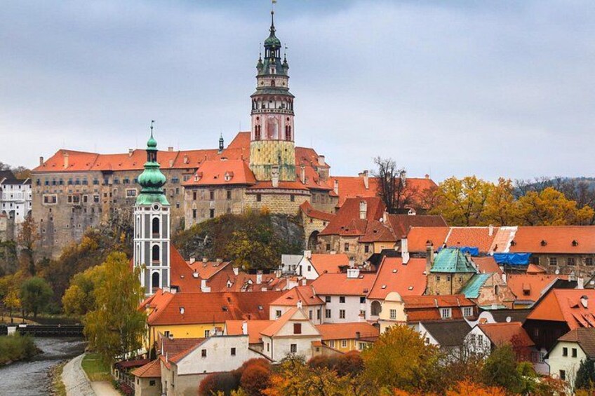 A historic town with a prominent tower and a large building with a clock tower. 1