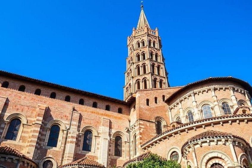 A historic cathedral with a prominent bell tower and arched windows. 5