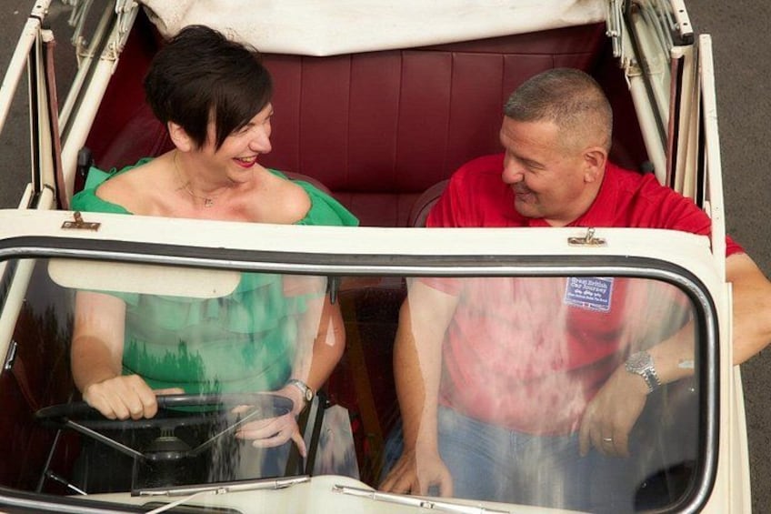 A vehicle with a red interior and a person in a green top. 3