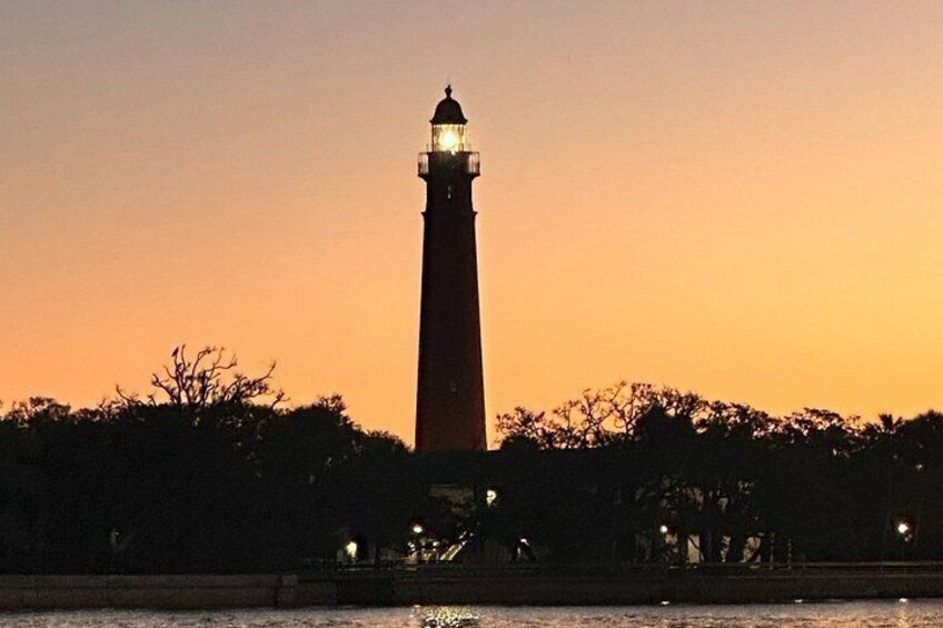 A lighthouse at sunset with a clear sky. 2