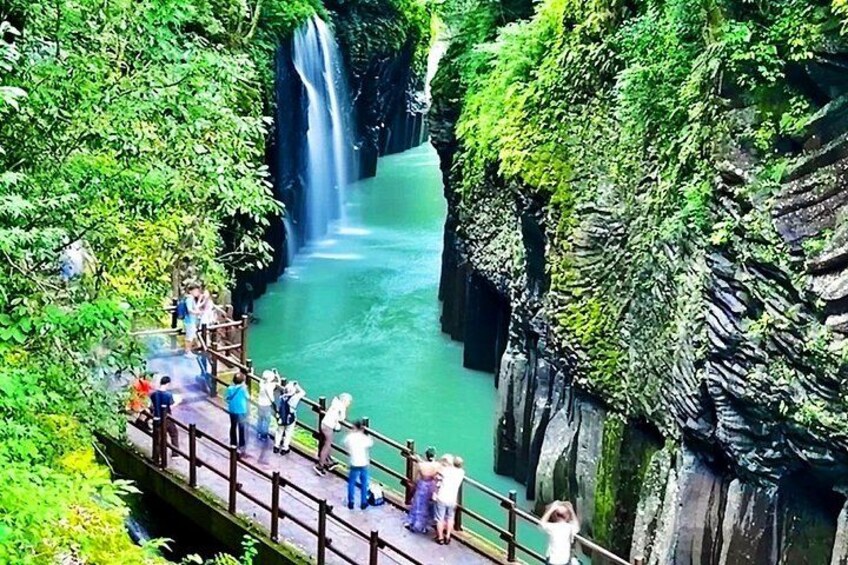 A waterfall, a river, and a bridge with people. 2