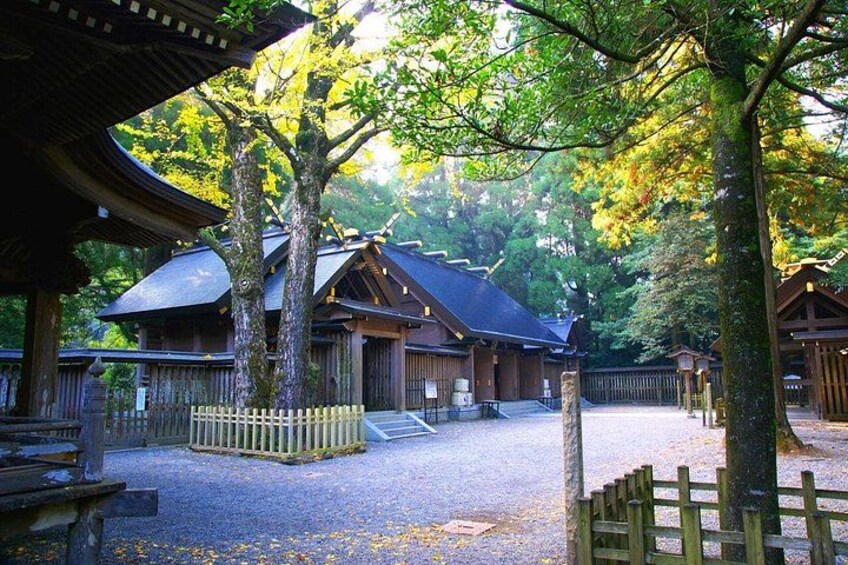 A traditional Japanese building surrounded by trees. 2