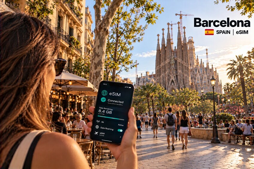 A person holding a smartphone displaying eSIM connectivity in Barcelona. 1