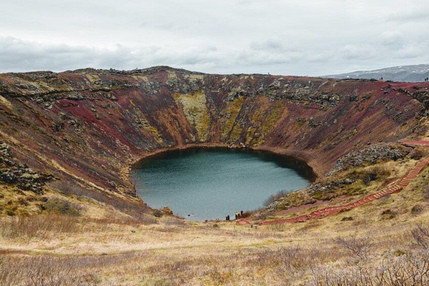 A large crater with a lake surrounded by colorful terrain. 4