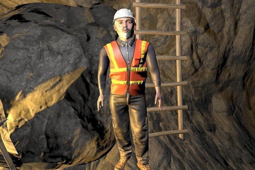 A person in a hard hat and safety vest standing next to a ladder in a rocky environment. 2