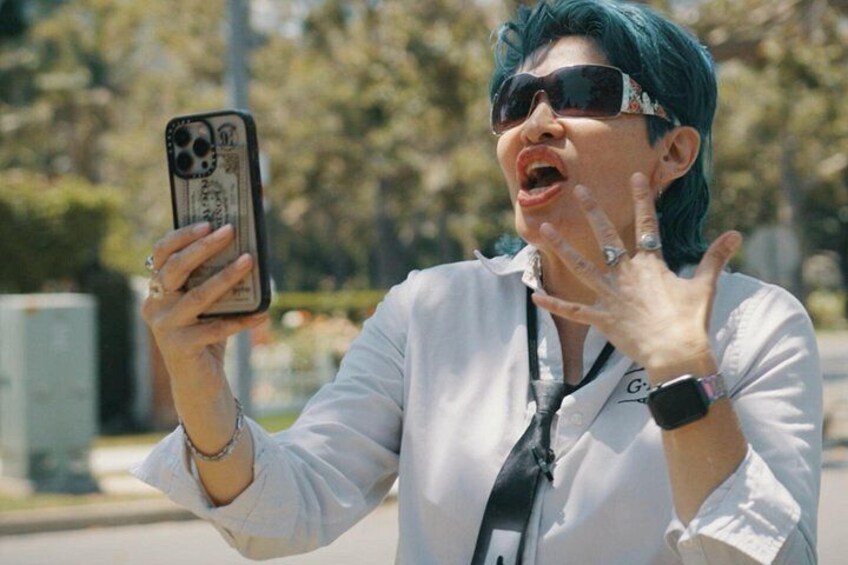 A person taking a selfie with a smartphone. 3