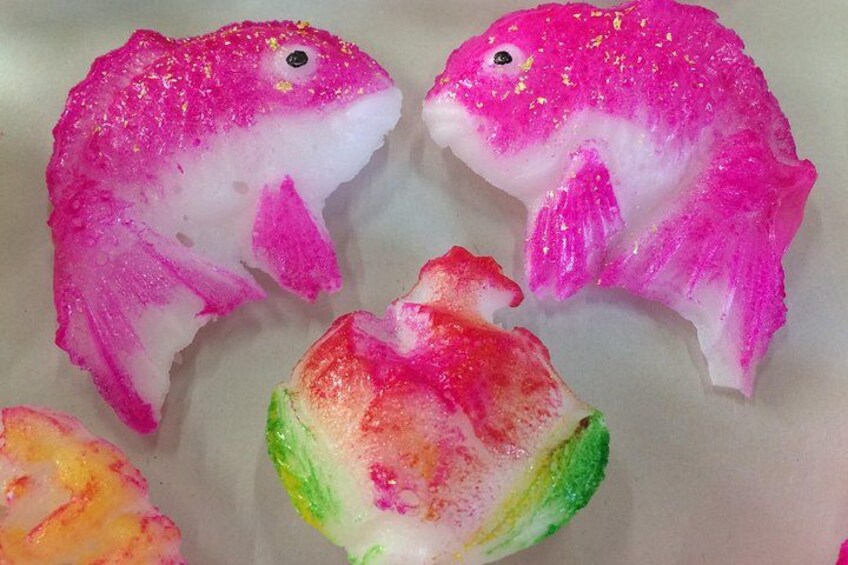 A collection of colorful, glittery fish-shaped objects. 2