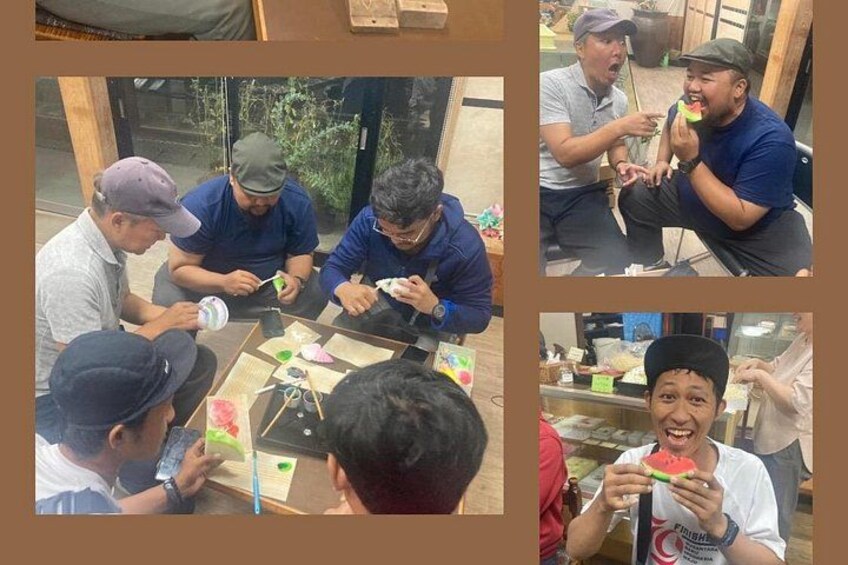 A group of people engaged in a craft activity, possibly making jewelry or decorations, with various tools and materials on a table. 1