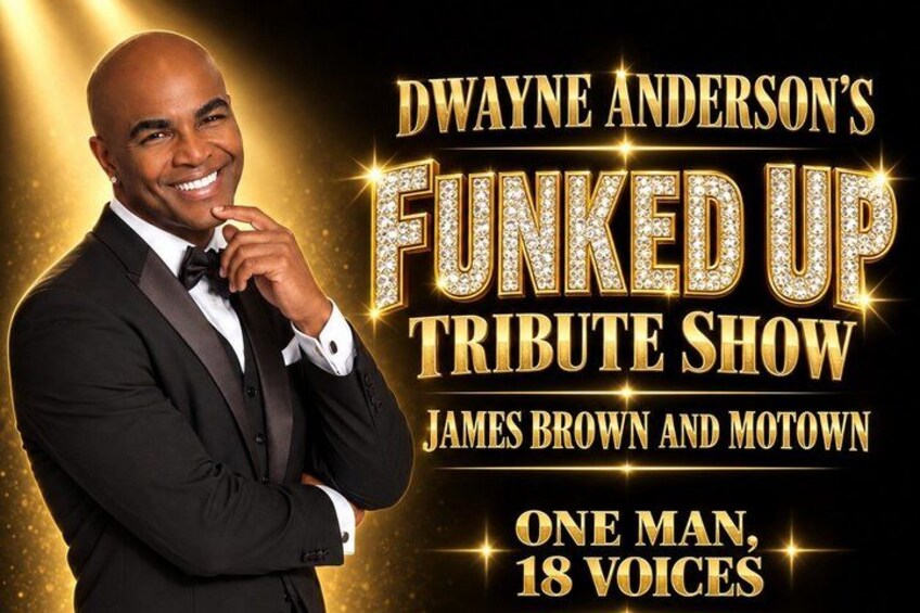 Dwayne Anderson in a black suit with a bow tie, standing with his hand on his chin. 2