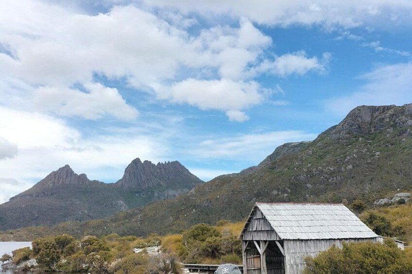 A mountainous landscape with a wooden structure in the foreground. 3