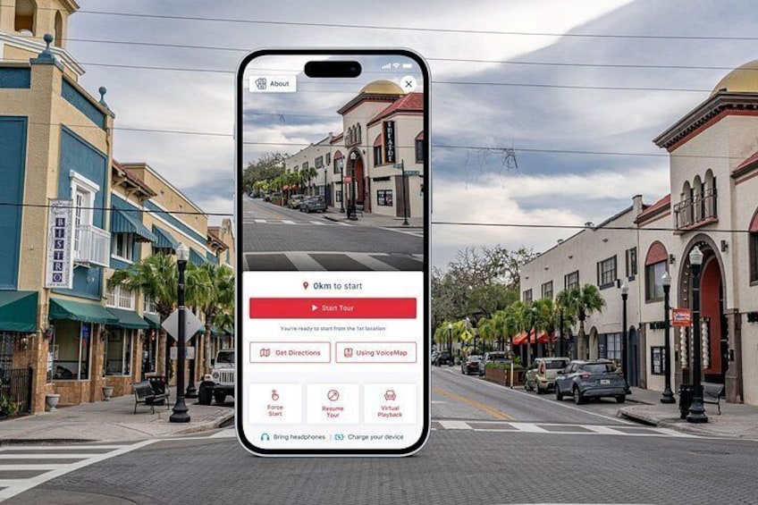Un smartphone affichant une application de cartographie avec une vue de rue d’une ville. 1