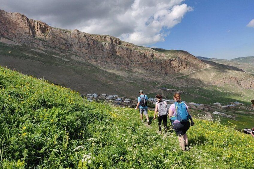 Hikers on a trail with a mountainous landscape in the background. 2