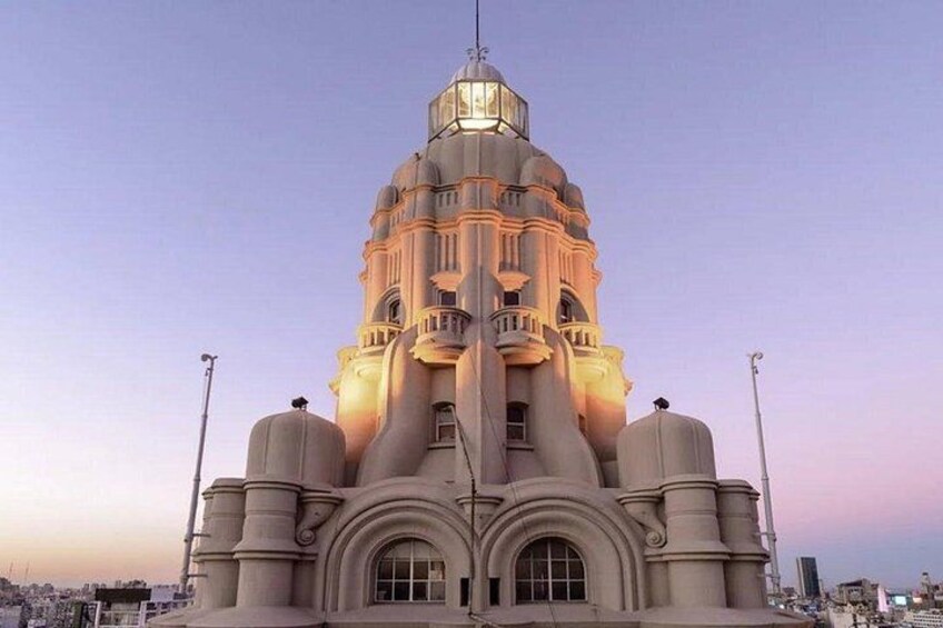 A large, ornate building with a dome and multiple towers, illuminated by artificial lighting. 2