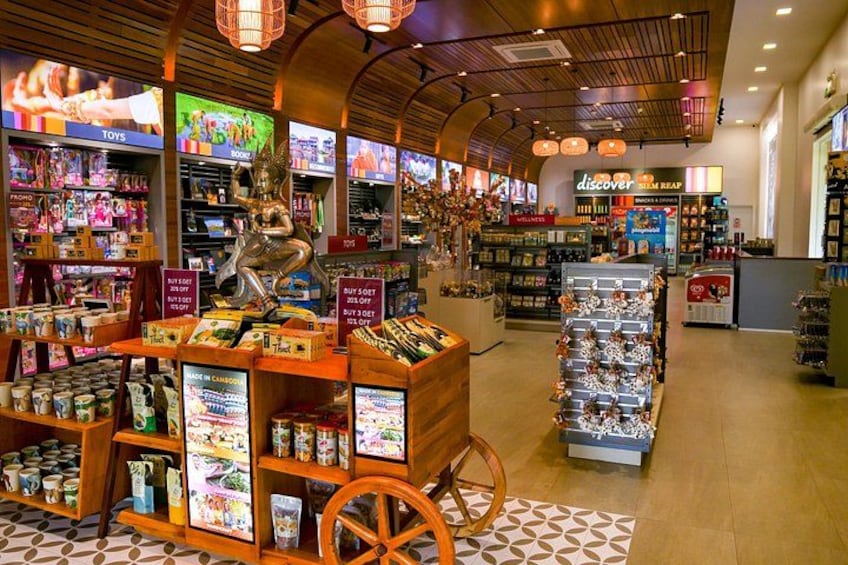 A brightly lit store with wooden shelves, a display cart, and a 'buy 1 get 1 free' sign. 4