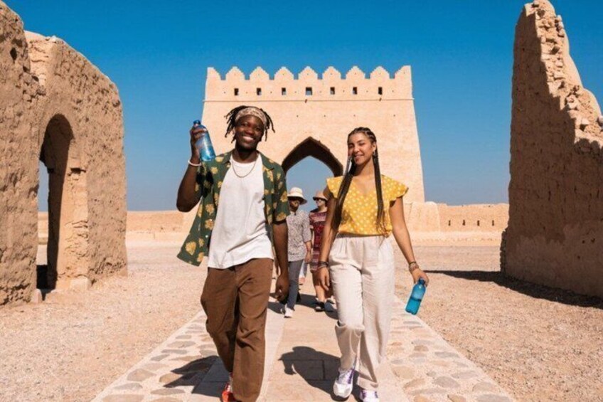 A historical site with ancient architecture, including a large wall and arched structures. 2