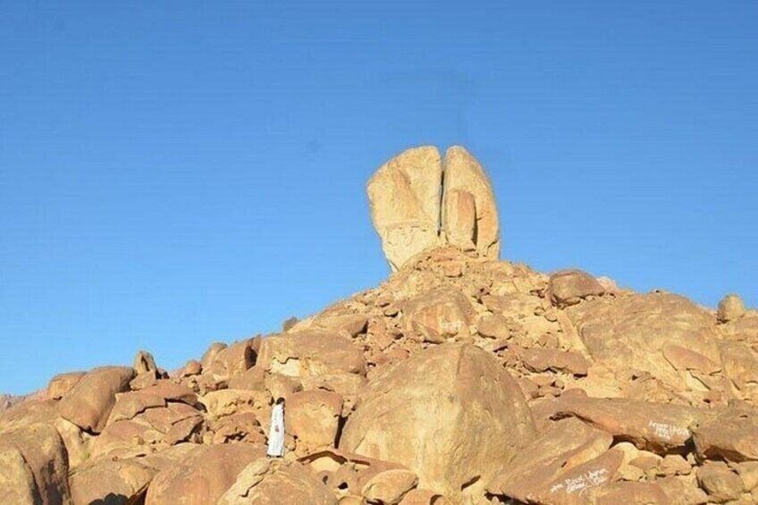 A rocky hill with a large boulder balanced on top. 3