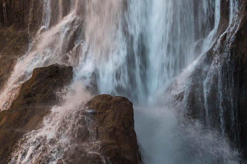 A waterfall cascading over rocks. 5