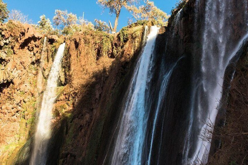 A multi-tiered waterfall cascading down a rocky cliff. 3