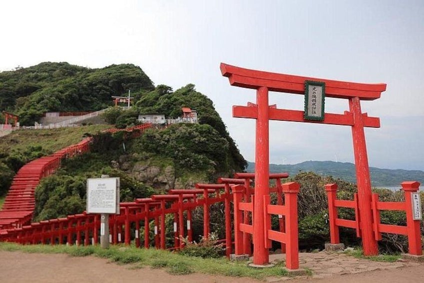 The Motonosumi Shrine's torii tunnel, with 123 red torii gates stretching along the hillside to the edge of a cliff, creates a breathtaking landscape with the blue sky, 1