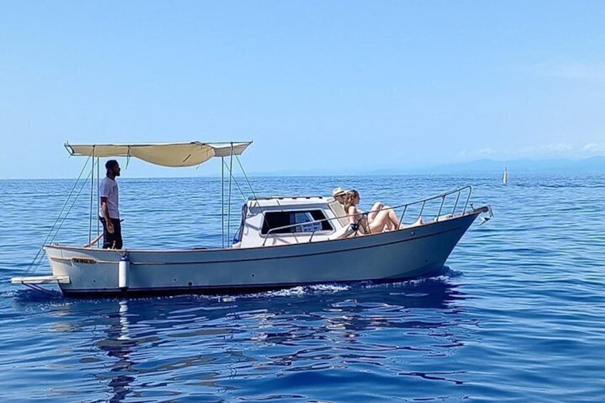 A small boat with a canopy on a calm sea. 2