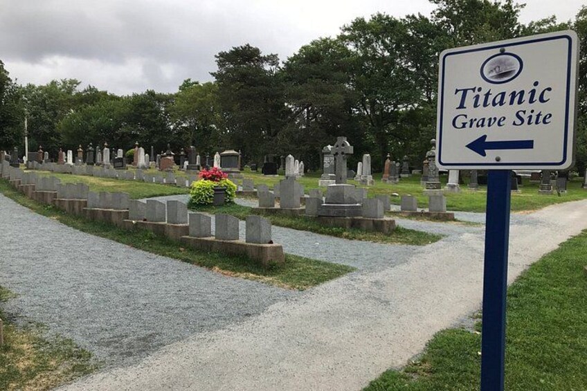 A cemetery with gravestones and a sign indicating the Titanic Grave Site. 2