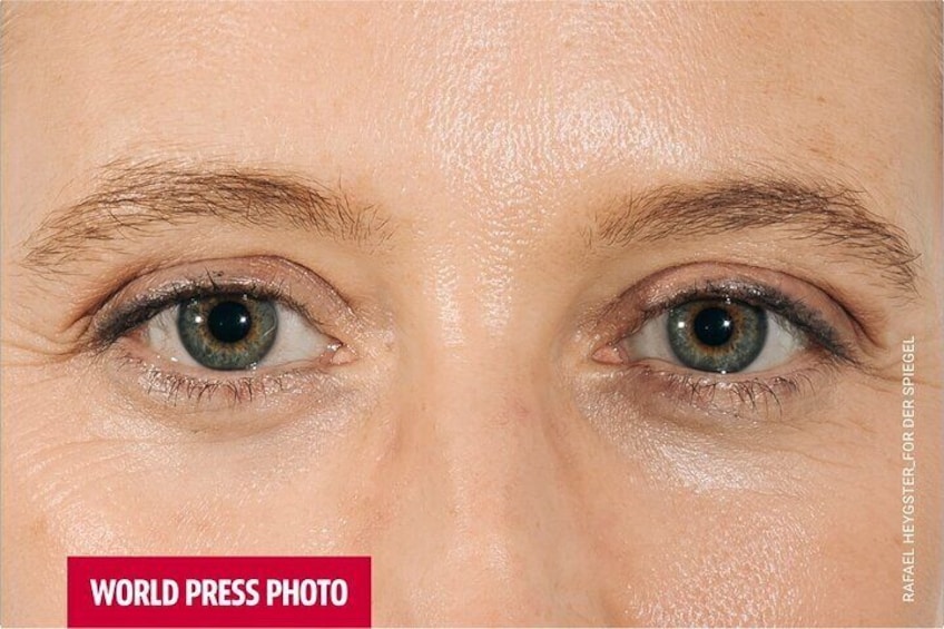 A close-up of a person's eye with a blurred background. 1
