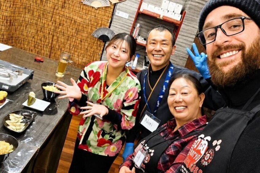 A group of people at a table with food and drinks. 3