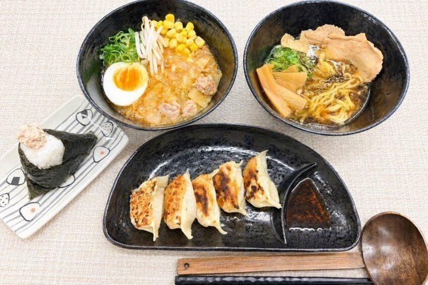 Three bowls of ramen with various toppings, a plate with dumplings, and a small dish with a half-boiled egg. 1